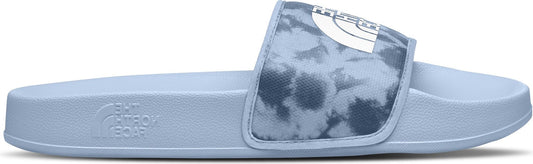 A slide sandal with light blue sole and tie-dye patterned strap with logo.