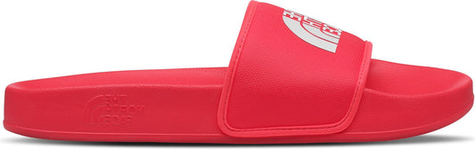 Red slide sandal with a white logo on the strap.