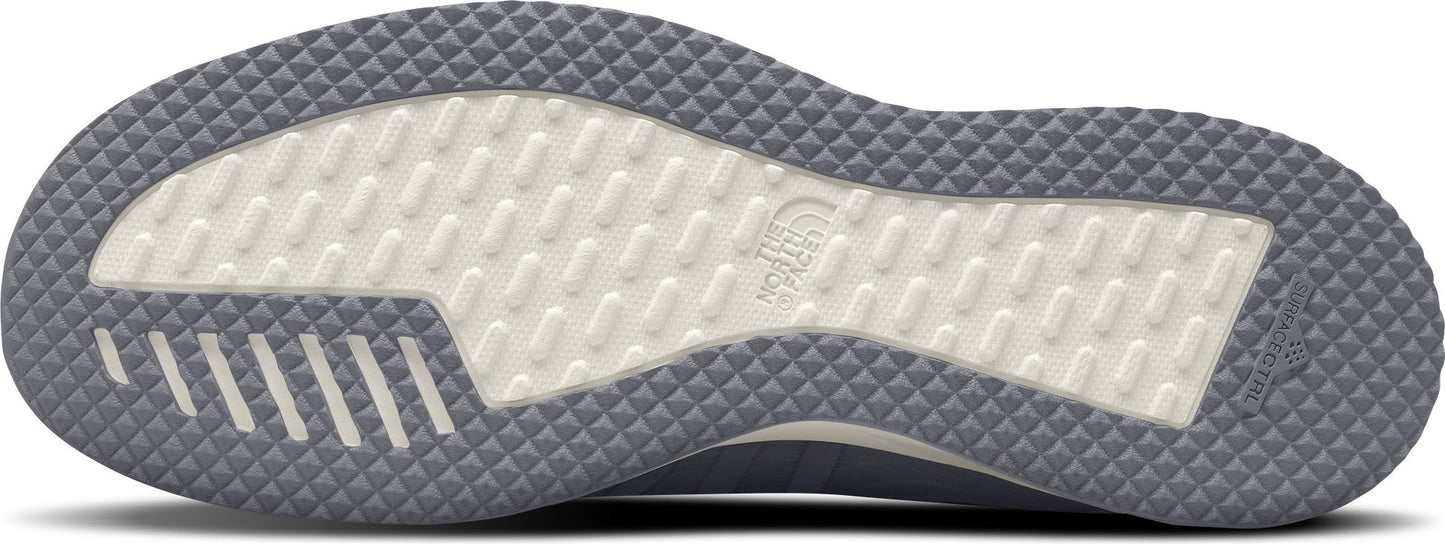 The sole of a shoe is gray with a white tread and embossed logo.