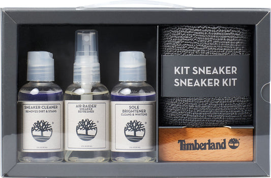 Shoe cleaning kit with three bottles labeled 'Sneaker Cleaner Removes Dirt & Stains', 'Air Raider Sneaker Refresher', 'Sole Brightener Cleans & Whitens', a wooden brush and a grey cleaning cloth.