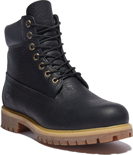 Black leather boot with golden eyelets and light brown sole.