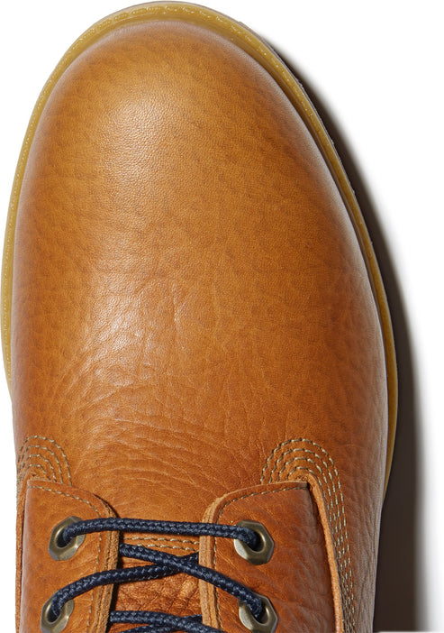 Top-down view of a wheat-colored leather boot featuring dark blue laces with metal eyelets.