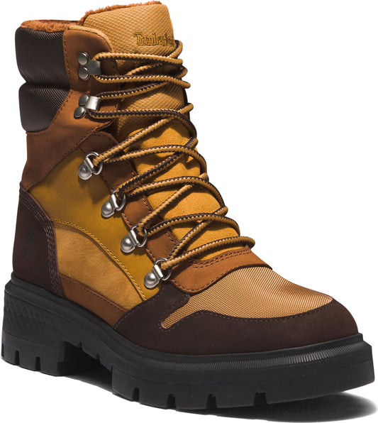 A high top boot featuring brown, yellow and tan suede and textile paneling with metal eyelets and laces on top of a black lug sole.