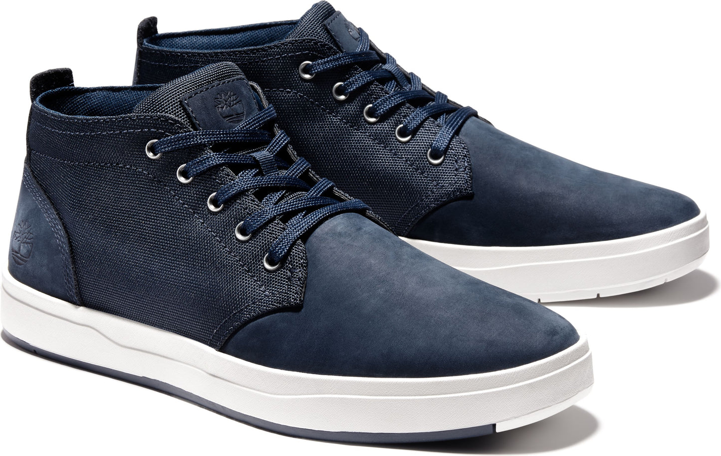 A pair of indigo suede chukka shoes with white soles.