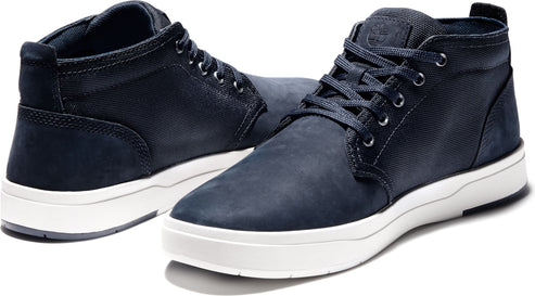 A pair of navy blue chukka sneakers with white soles.