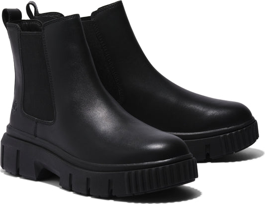 A pair of black, leather Chelsea boots with chunky lug soles.