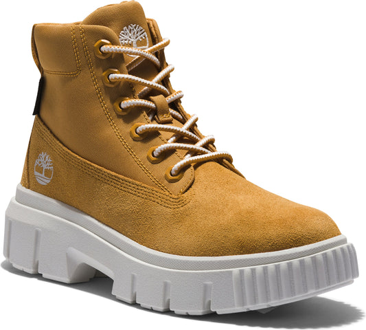 Tan-colored nubuck leather ankle boot with white laces and a thick, white lug sole.