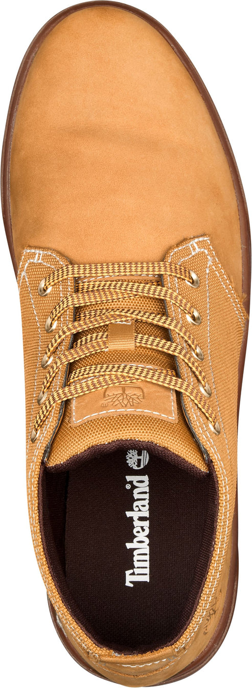 Tan-colored lace-up shoe with a rubber sole and visible Timberland logo on the insole.