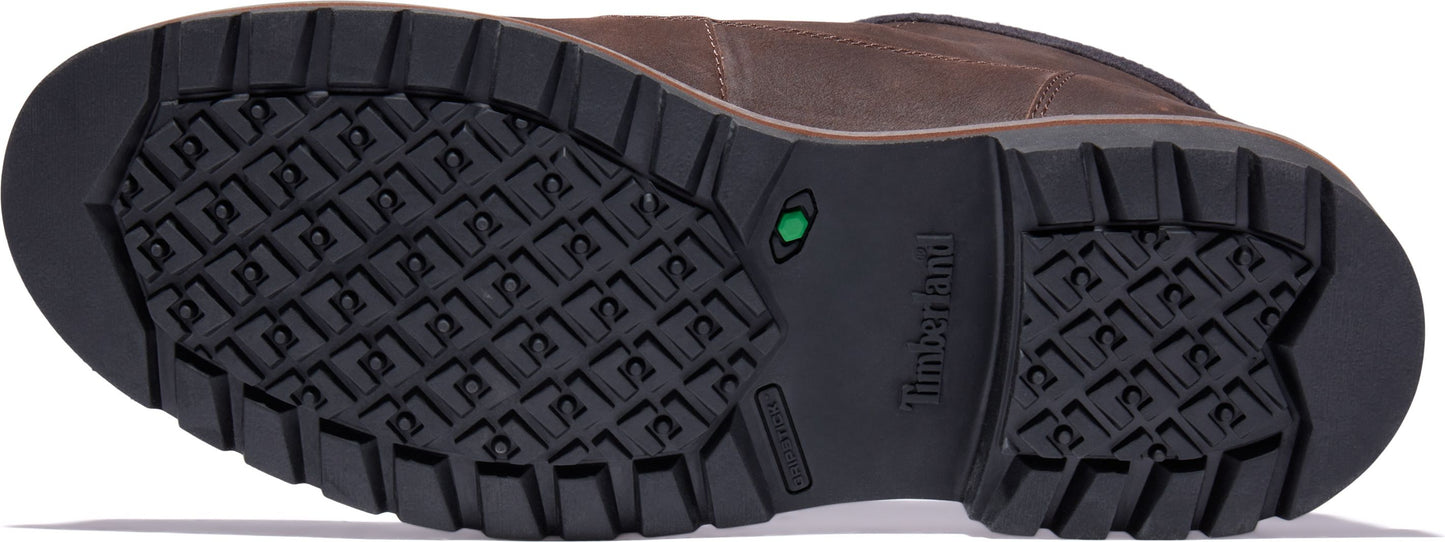 The sole of a brown shoe with a black rubber bottom featuring a grid pattern.