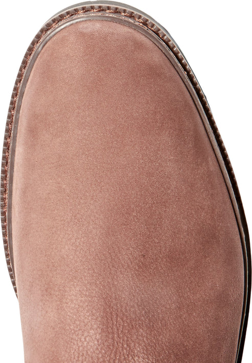Close up of a round toe of a light brown boot with stitching.