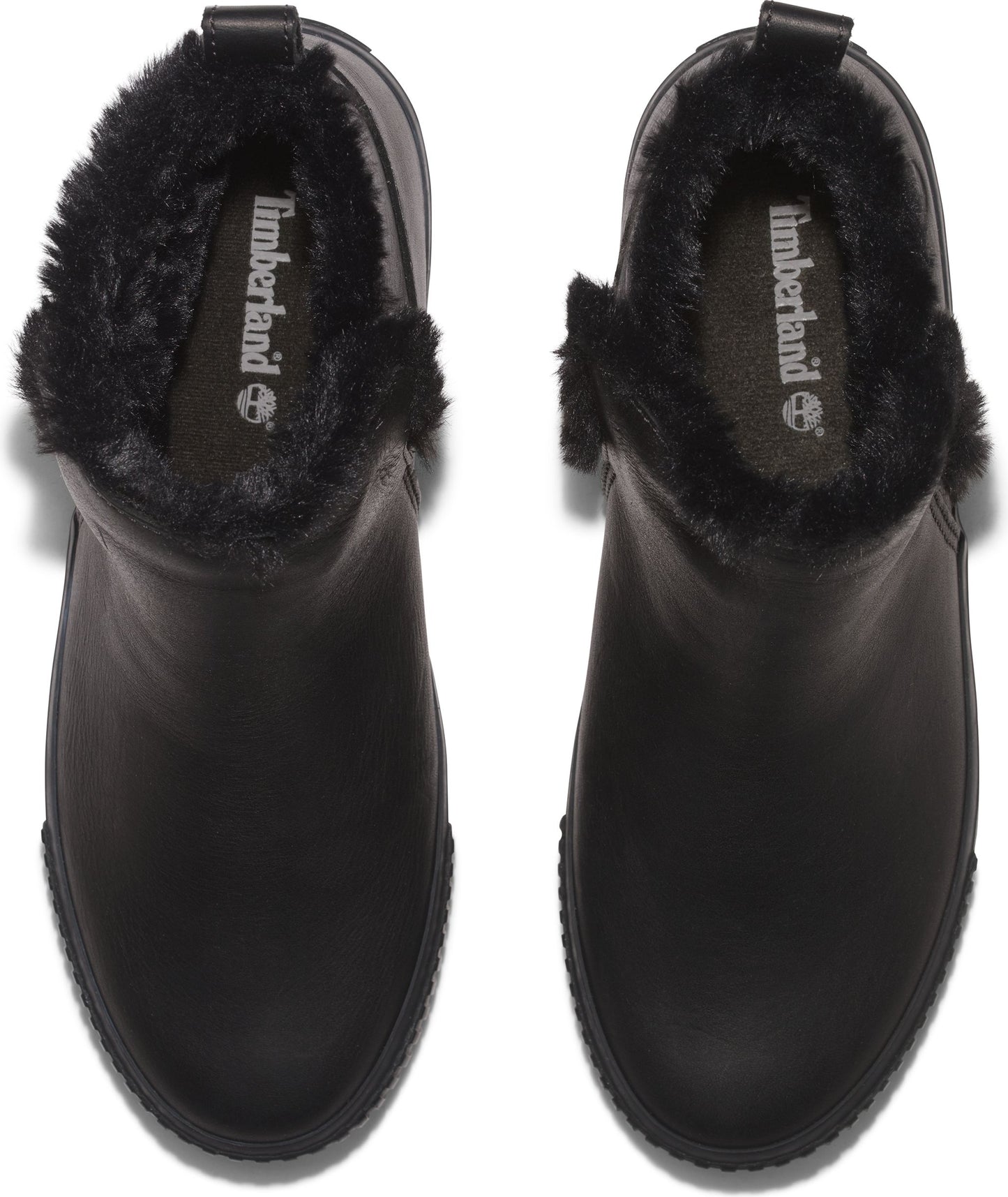 Overhead view of two black Chelsea-style leather ankle boots with faux fur lining.