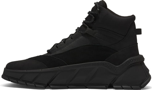 Black high-top shoe with thick, angular sole, featuring fabric and suede panels and a pull tab at the heel.