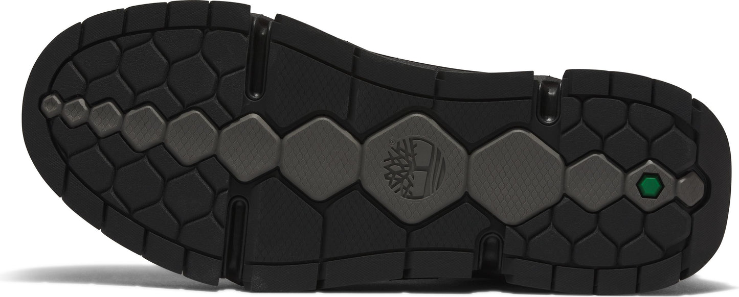 A black sole with a network of hexagon-shaped treads, some with the Timberland logo and a green hexagon detail.