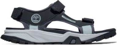 A black and gray sandal with hook-and-loop closures and a logo showing a tree.