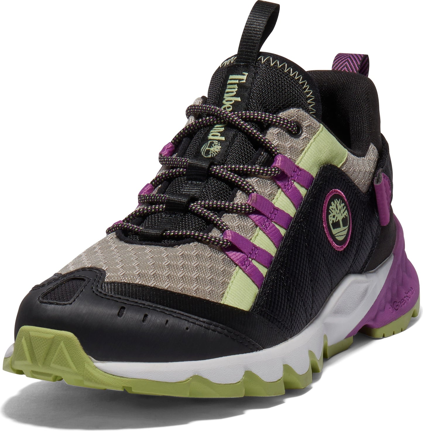 Athletic shoe with a black toe, a beige mesh midsection, purple eyestay bands, and a black ankle, contrasted by a white jagged sole with green and purple accents.