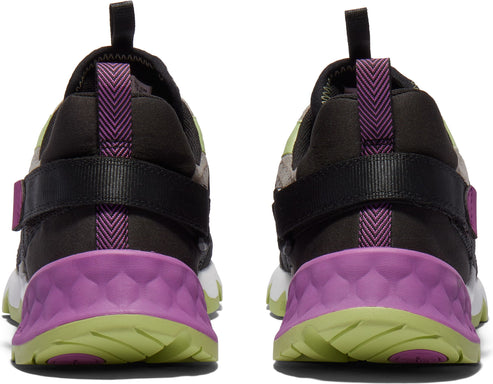 Pair of sneakers featuring black straps, purple accents, and green outsoles viewed from the rear.