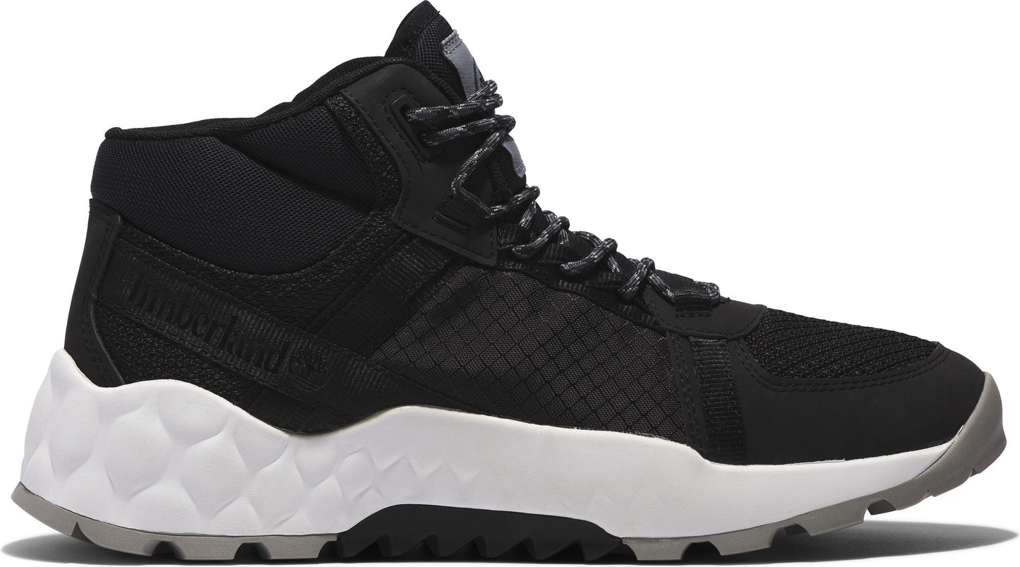 Black and white mid-top hiking shoe with a textured white sole.