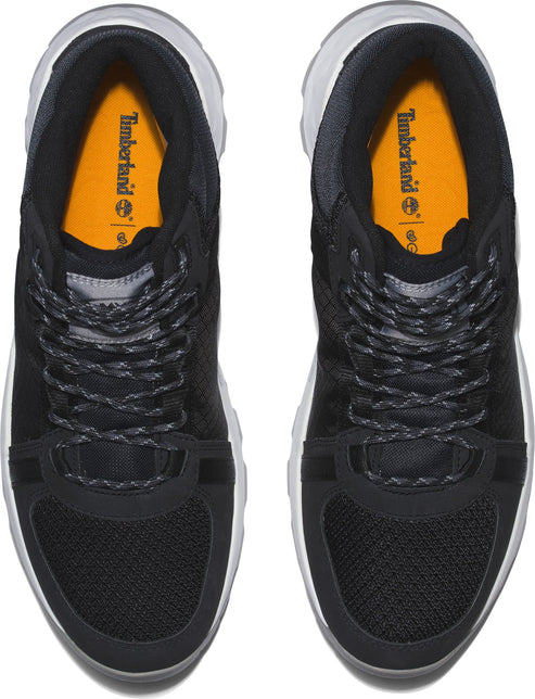 Overhead view of a pair of black sneakers with white soles and orange insoles.