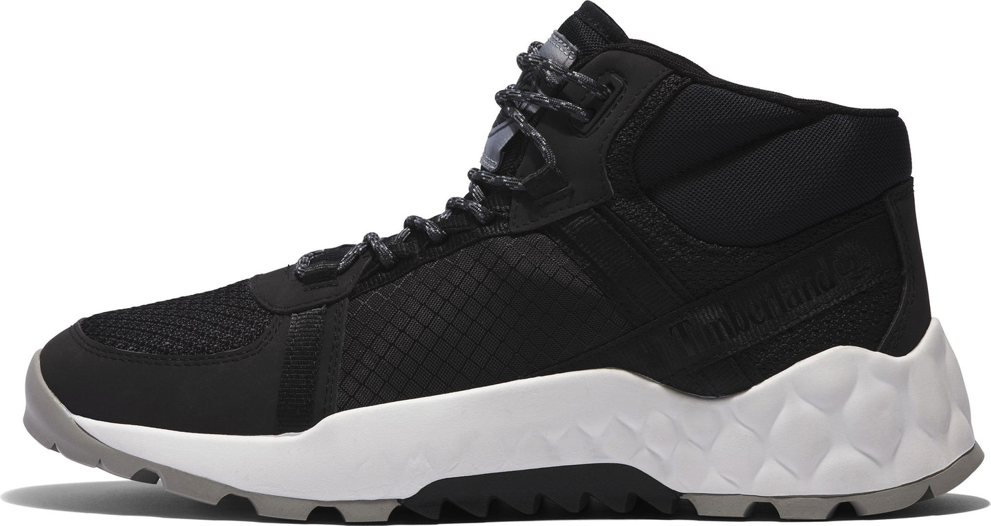 Black and white high-top athletic shoe with geometric-patterned sole and speckled laces.