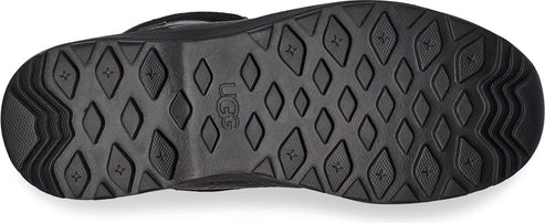 Sole of a black boot with diamond and star shaped tread patterns.