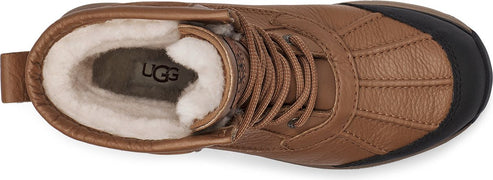 Tan UGG boot with black toe and tan laces, fur lined interior.