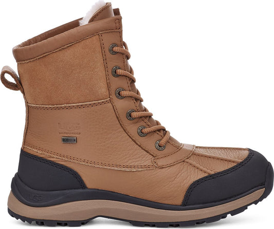 A tan leather lace-up duck boot with a black rubber toe, fur lining, and waterproof detail.