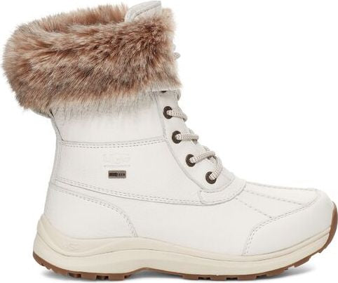 White waterproof winter boot with faux fur trim and lace-up closure.