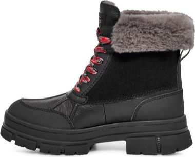 Black lug sole boot with gray faux fur trim and red and black laces.