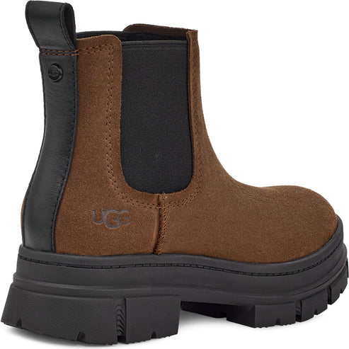 Chelsea boot with brown suede upper, black heel and sole, and elastic side panels.