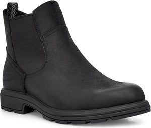 A black, leather Chelsea boot with a round toe, black elastic side panels, and a black rubber sole.