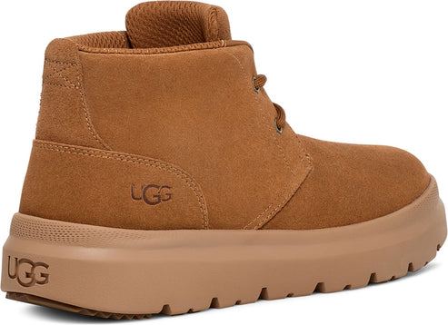 Saddle-brown suede chukka boot with a matching thick sole and "UGG" printed on the side.