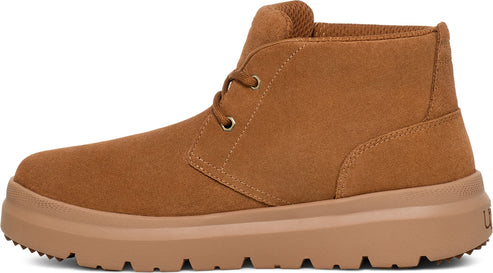 Tan suede chukka boot with a thick, ribbed sole and eyelet lacing.