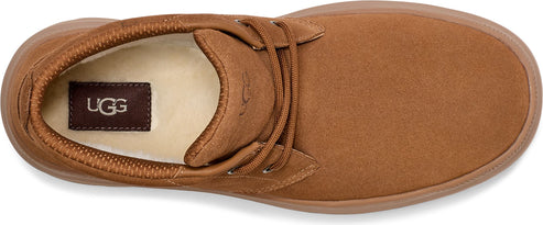 A brown shoe with laces and an UGG logo on the insole.
