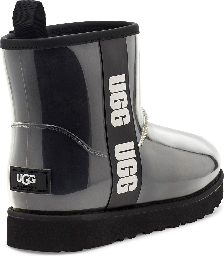 Back view of black waterproof ankle boot with a rubber sole, a pull tab, and a white text on the side.