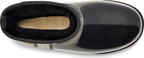 Overhead view of a clear rain boot with black lining and a tan insole.