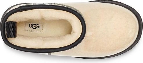 top view of an ankle boot with a black trim and UGG logo on the insole