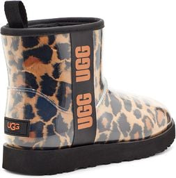 Ankle boot with transparent leopard print pattern, black sole, black trim, and the letters UGG stacked vertically in orange on a black strip.