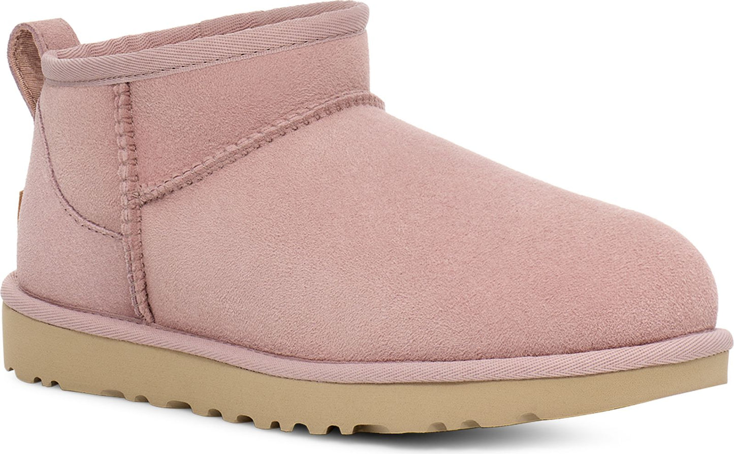 Dusty rose UGG bootie with a light-brown, lugged sole and a loop at the back.