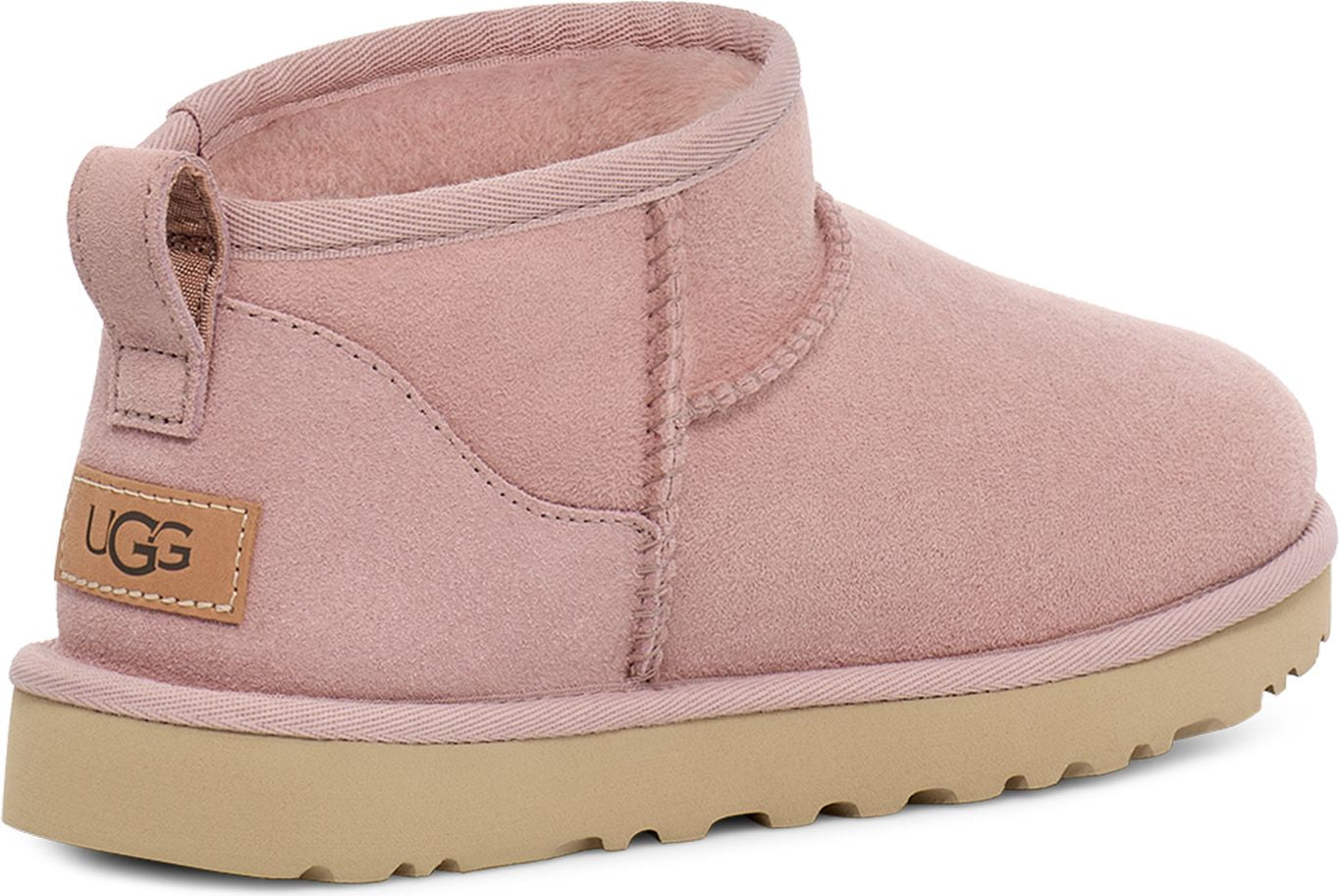 Low-cut, pink suede boot with beige sole and fabric pull tab.