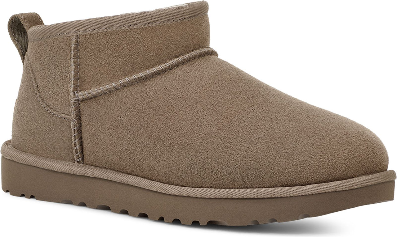 Short, taupe suede boot with a matching sole and a pull tab on the back.
