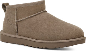 Short, taupe suede boot with a matching sole and a pull tab on the back.