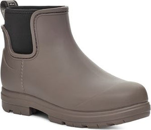 Taupe ankle-high rain boot with black elastic side panels.