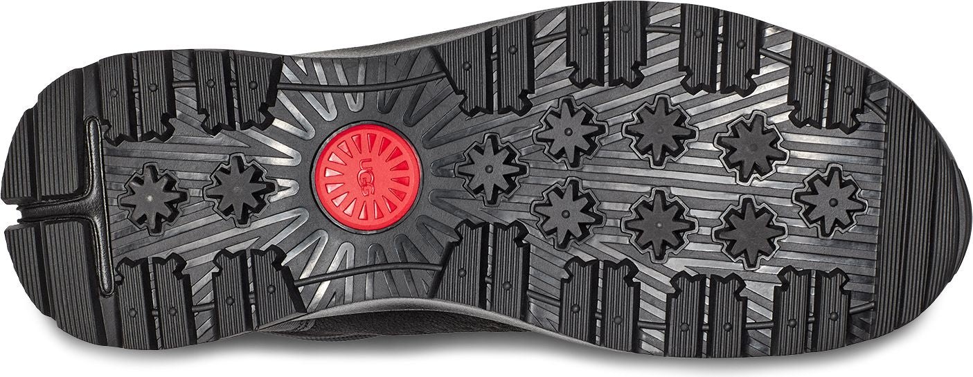 A shoe sole with a red center and intricate patterns.