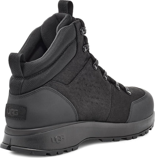 Black high top boot with metal eyelets and a thick sole.