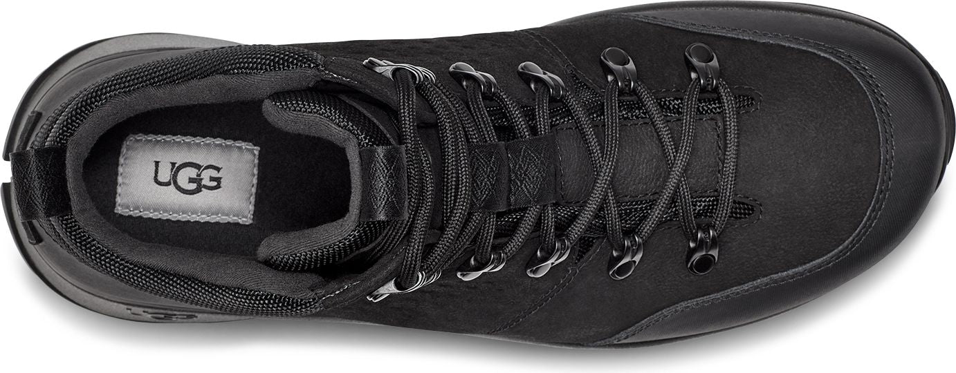 Black boot with shoelaces and UGG logo inside.