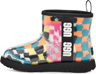 Short UGG boot with a multicolored blurred checker pattern and black sole and trim, with "UGG UGG" vertically printed in white letters.