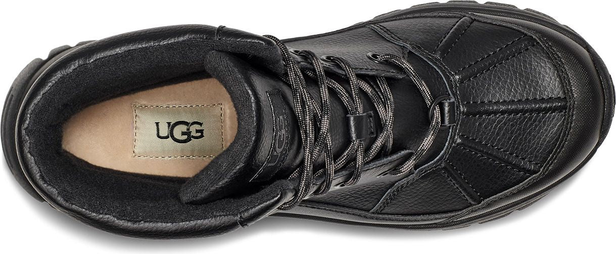 A black boot with the UGG logo on the inner sole.