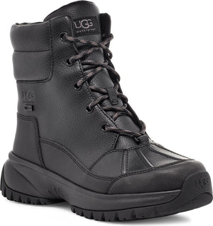 Waterproof black lace-up boot featuring a thick lugged sole and padded collar. The tongue features visible text 'UGG'.