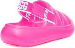 Bright pink slide sandal with the letters UGG in white on the strap.