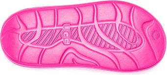 A bright pink sole of a slipper with UGG logo in the middle.